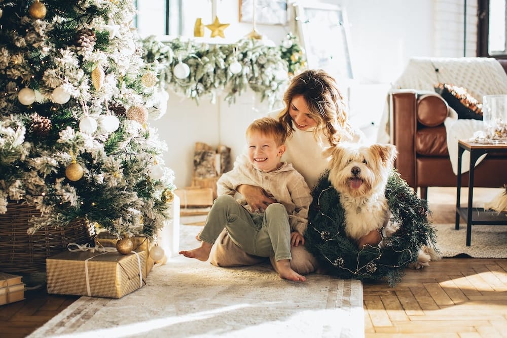 Dog and family by Christmas tree